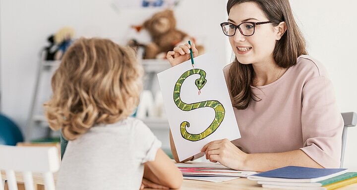 Logoped učí dítě písmeno „S“ jako součást podpory řečového vývoje.
