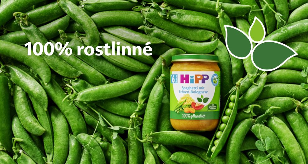 Na lůžku ze zeleného hrášku je umístěna sklenice s dětskou výživou a nad ní je nápis "100% rostellarne".