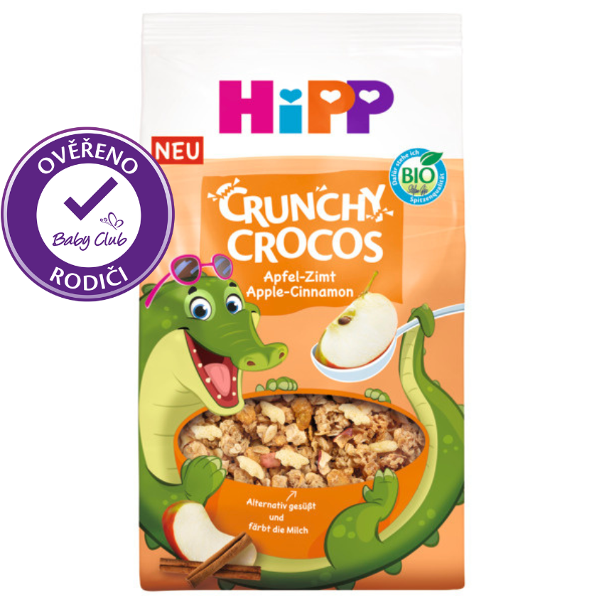Je zobrazeno balení cereálií Crunchy Crocos s postavičkou zeleného krokodýla s příchutí jablka a skořice.